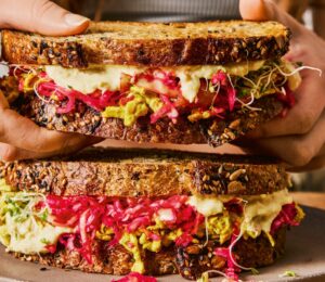 gut-loving sourdough sandwich with pink sauerkraut, hummus, and tofu