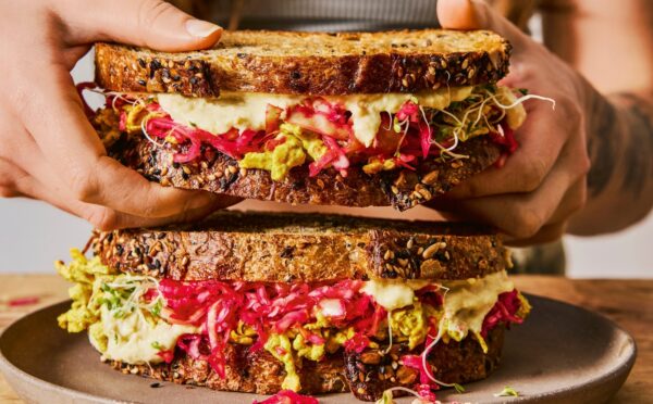 gut-loving sourdough sandwich with pink sauerkraut, hummus, and tofu