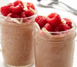 raspberry, chocolate, and almond chia pudding with almond butter, cocoa powder, and bright fruit