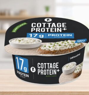 Photo shows the new vegan cottage cheese product, COTTAGE PROTEIN+, from Austrian food tech startup Revo Foods, against a stock kitchen background. The packaging is black, blue, and white. Revo Foods just launched a high-protein vegan cottage cheese made with fermented, upcycled apricot kernels