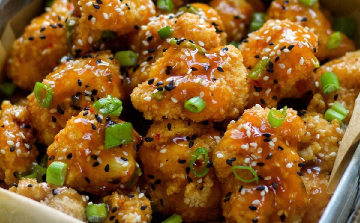 Spicy Sesame Cauliflower Wings with a sauce and green onion for vegan sesame recipes