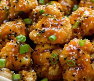 Spicy Sesame Cauliflower Wings with a sauce and green onion for vegan sesame recipes