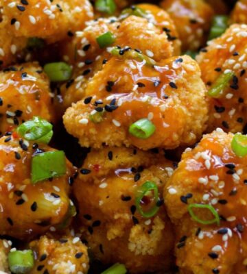 Spicy Sesame Cauliflower Wings with a sauce and green onion for vegan sesame recipes