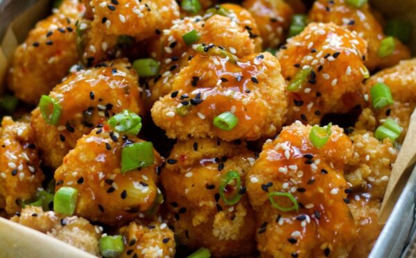 Spicy Sesame Cauliflower Wings with a sauce and green onion for vegan sesame recipes