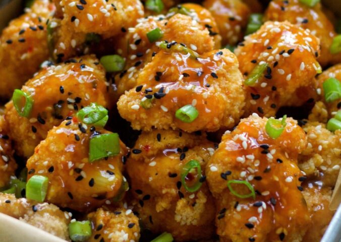 Spicy Sesame Cauliflower Wings with a sauce and green onion for vegan sesame recipes