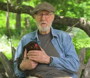Photo shows vegan actor James Cromwell holding Hermione, a rescued hen. Cromwell appears in a new campaign video for PETA, in which he debunks the cage-free “lie” and encourages people to eat vegan eggs