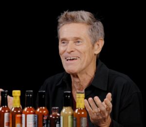 Photo shows Willem Dafoe during his recent appearance on the YouTube talk show 'Hot Ones,' where he chose to eat vegan chicken nuggets. The celebrated actor does not follow a vegan diet, but has said on multiple occasions that he doesn’t eat meat
