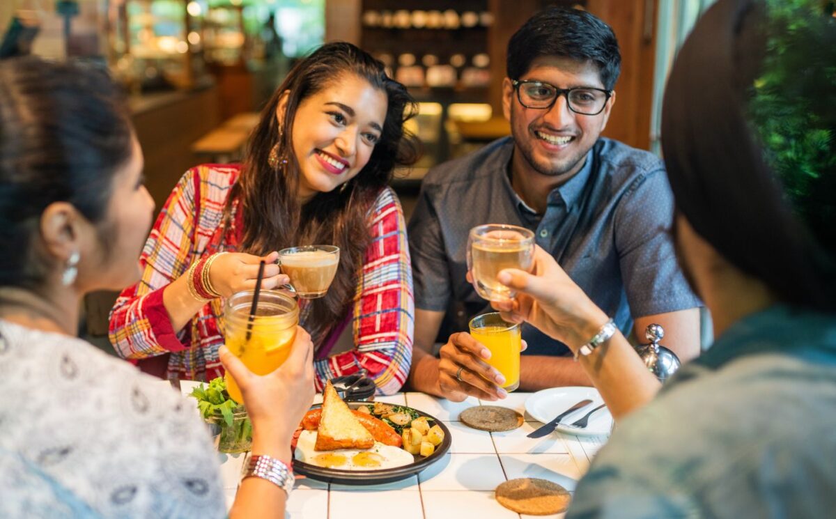 Photo shows a group of young Indian friends eating at a cafe. New research has found that most consumers in urban India would buy cultivated meat