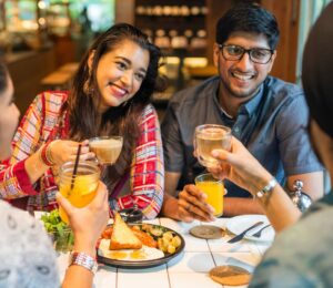 Photo shows a group of young Indian friends eating at a cafe. New research has found that most consumers in urban India would buy cultivated meat