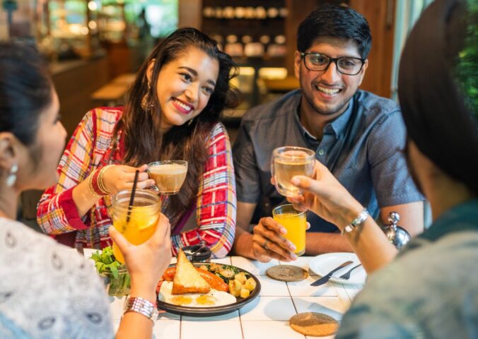 Photo shows a group of young Indian friends eating at a cafe. New research has found that most consumers in urban India would buy cultivated meat