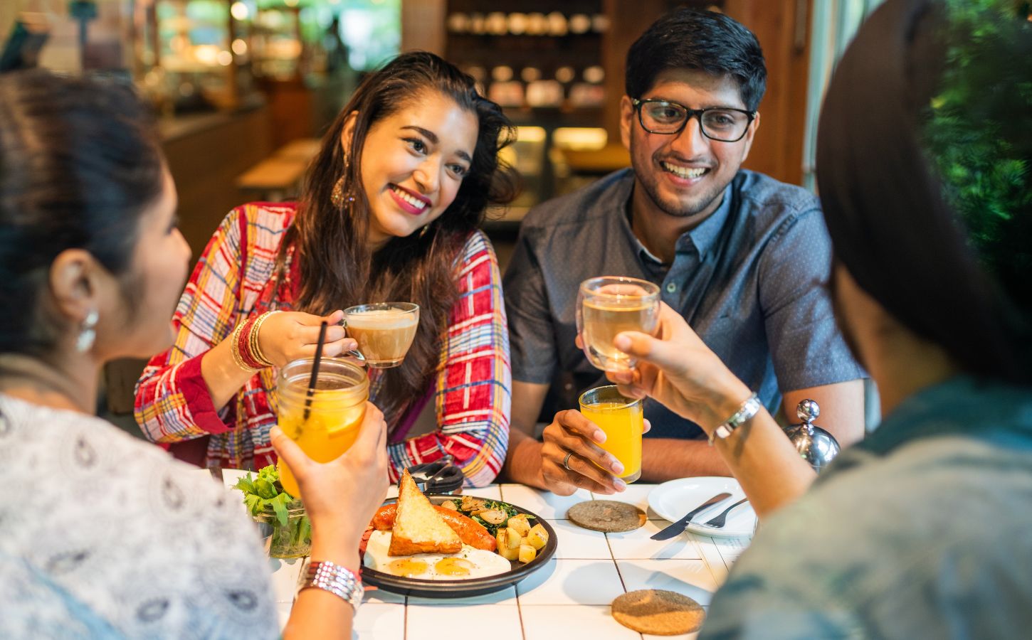 Photo shows a group of young Indian friends eating at a cafe. New research has found that most consumers in urban India would buy cultivated meat