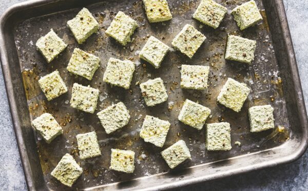 a tray of seasoned pumpkin seed tofu cubes for seed-filled recipes