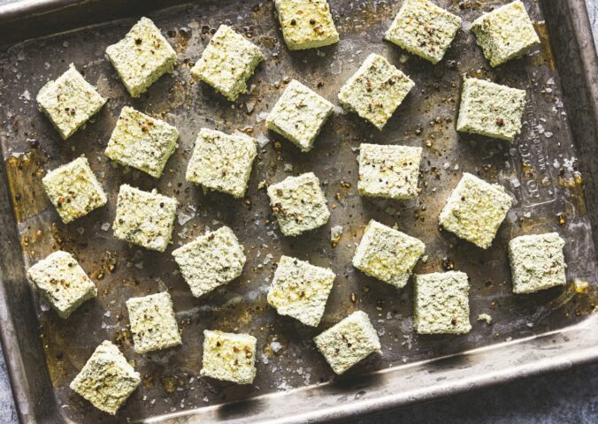 a tray of seasoned pumpkin seed tofu cubes for seed-filled recipes