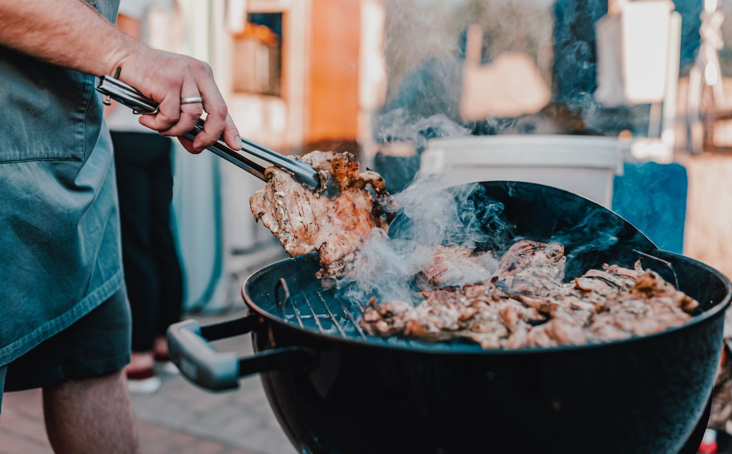 Photo shows a man's hand as he BBQs red meat. Scientists analyzed the supposed benefits of carnivore diets and found the evidence base to be “thin.”