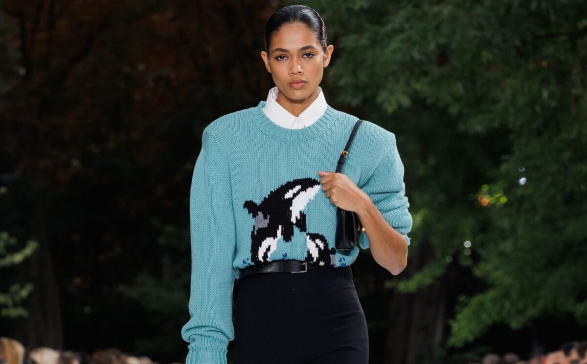 Photo shows a model wearing an ocean-inspired, wool-free knitted jumper bearing the image of two orcas while on the runway at a recent fashion show by designer Stella McCartney, who said, “Sea life, not sea food."