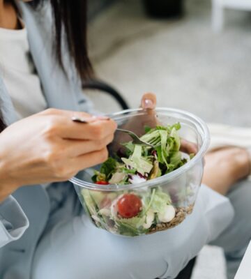 Swap meat for vegetables and cut chronic disease risk in the UK. Photo shows a woman eating a large bowl of fresh salad at her desk. According to a new study, reducing red and processed meat consumption in favor of vegetables and legumes could significantly reduce the number of chronic disease cases in the UK