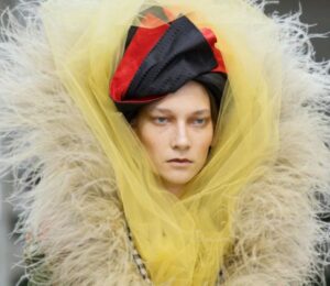 Photo shows a model wearing one of Vivienne Westwood's new outfits featuring vegan feathers by FEVVERS.
