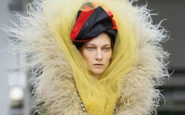 Photo shows a model wearing one of Vivienne Westwood's new outfits featuring vegan feathers by FEVVERS.