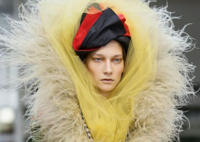 Photo shows a model wearing one of Vivienne Westwood's new outfits featuring vegan feathers by FEVVERS.